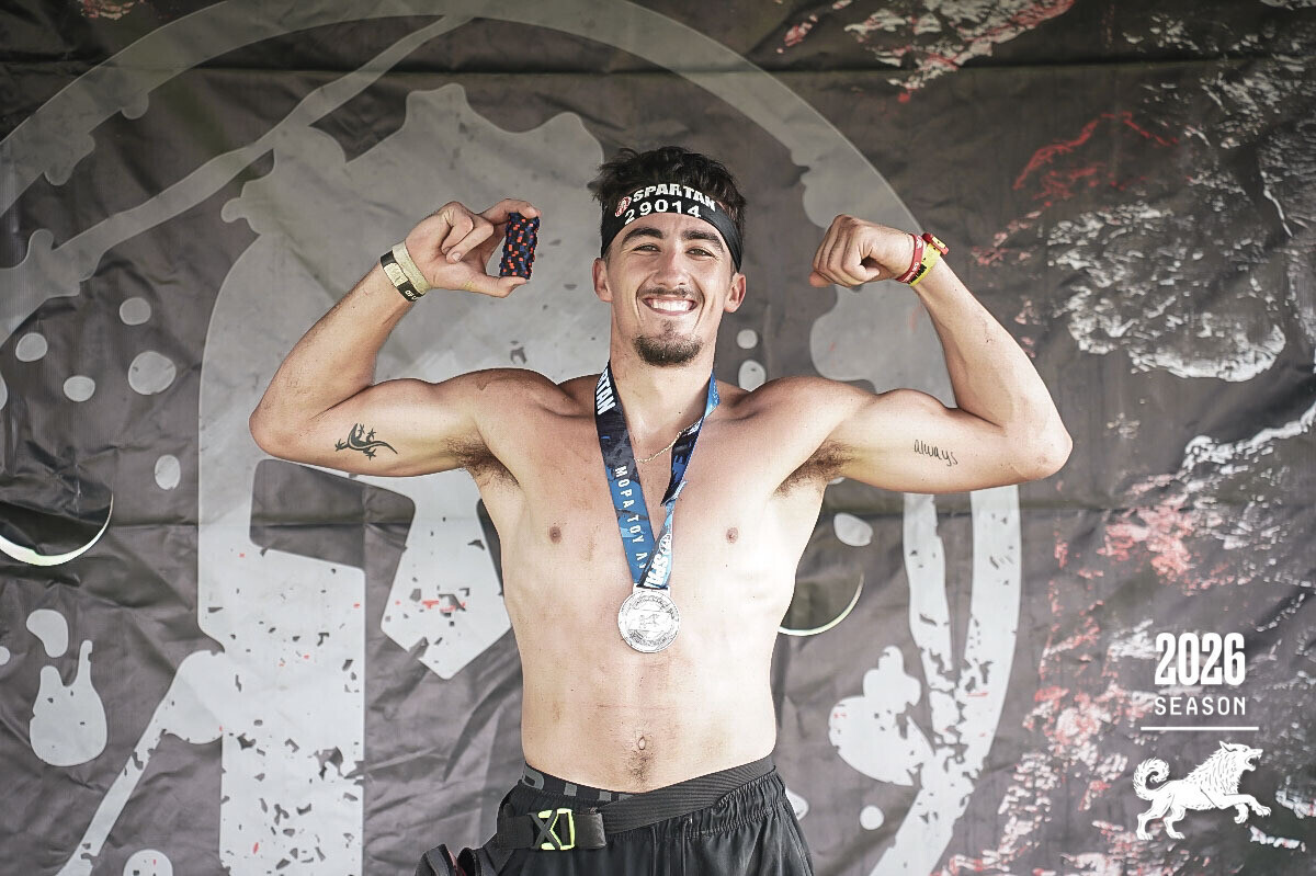Sean celebrating with his Spartan Super 10K and Sprint 5K finisher medals